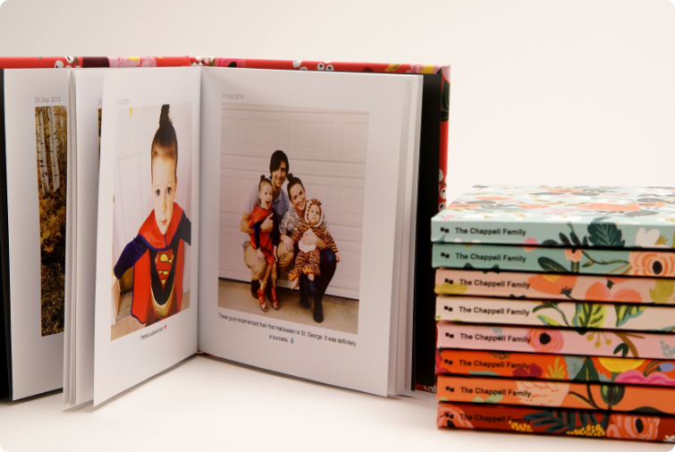 Image of an open photobook showing family pictures and other closed photobooks